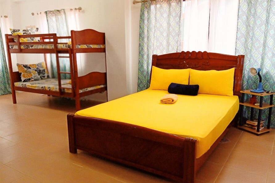 Flagship image of the spacious VIP Executive Suite San Carlos resort, showing queen bed and capacity for extra guests on the bunk bed.