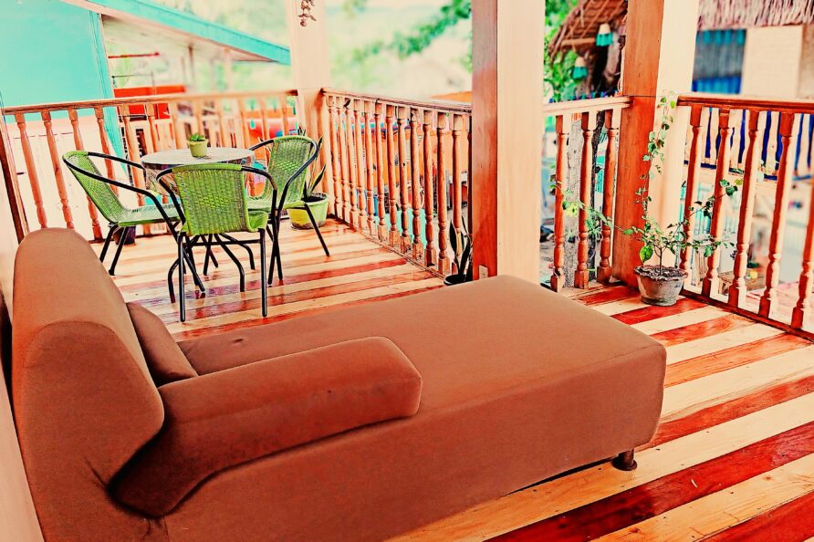 Wide view highlighting the expansive size and luxury woodgrain finish of the private balcony at the VIP Executive Suite San Carlos resort.