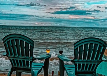 Muskoka chairs with wine glasses and beautiful blue sea view for relaxing family reunion venue moments