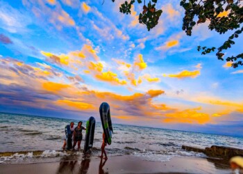Group of boys playing on beach at sunset at family reunion venue bacolod