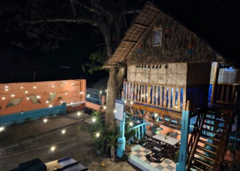 Illuminated treehouse and intimate dining table at night at large group family reunion venue bacolod
