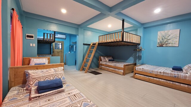 Casa Maria sleeping quarters with colorful bedding and drapes for large family reunion venue accommodation