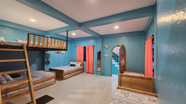 Casa Maria sleeping quarters with colorful bedding and drapes for large family reunion venue accommodation