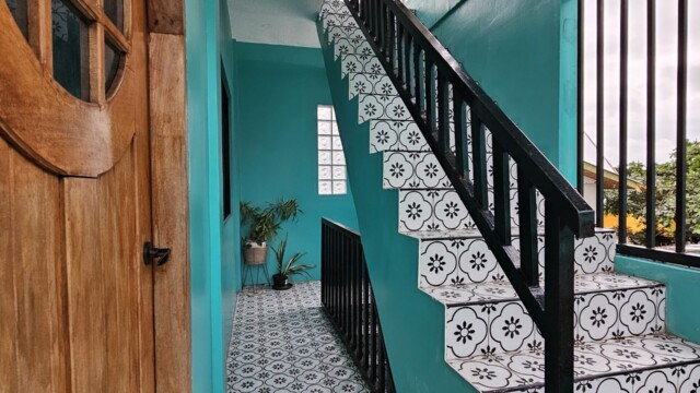 Beautiful staircase and woodgrain door separating sleeping and function areas in Casa Maria large group accommodation