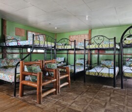 Ideal for large groups, team builders, and family reunions. Large group capacity interior thumbnail of the Filipino Family Cottage with a balcony at SmallFry's San Carlos City resort.