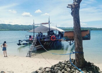 Ultimate Party Boat excursion anchored at pristine Tinisen Island beach for family gatherings