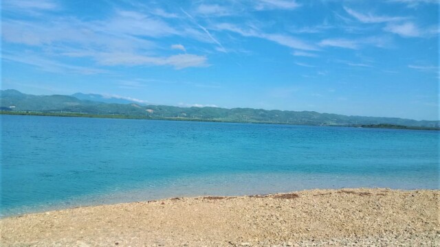 Paradise Found: The unique blue waters and coral sand of Campo Labo—a memorable stop on your private island hopping tour. Coral sand and blue sea view from Campo Labo Island Hopping